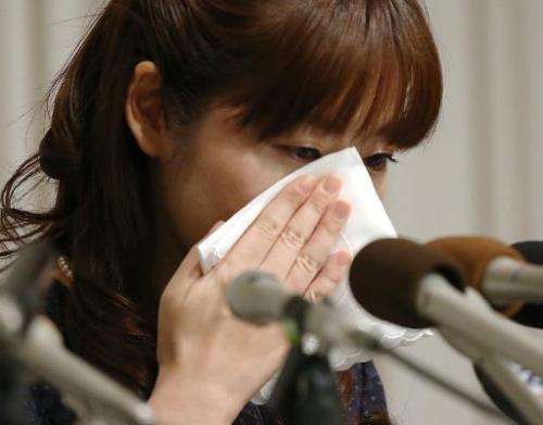 Haruko Obokata, 31, a researcher at Japan's Riken institute, wipes away tears during a press conference in Osaka, western Japan,