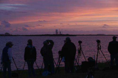 Photographers set up before the scrubbing of an attempt at launching the United Launch Alliance Delta 4 rocket carrying NASA's f