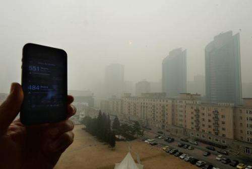 File photo of a cellphone showing the US Embassy pollution index reading of 551, which is extremely hazardous, and the Chinese g