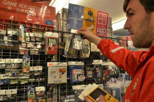 A customer checks out used Game Boy consoles a videogame shop in Tokyo, on April 17, 2014