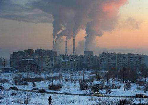 A file picture taken on January 31, 2012 in Sofia shows the sun rising behind chimneys of a thermal power station