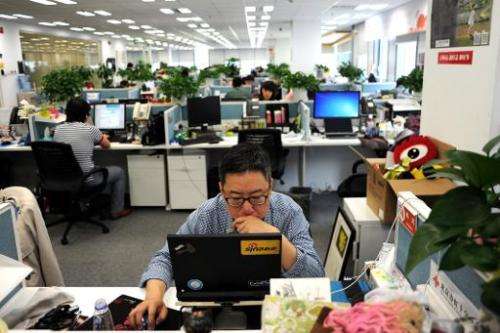 A man uses a laptop at an office of Sina Weibo, China's equivalent to Twitter, in Beijing on April 16, 2014