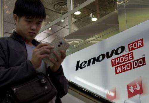 A man walks past an advertising billboard for Chinese technology giant Lenovo in Hong Kong on February 4, 2014