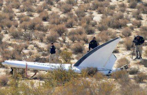 A National Transportation Safety Board team surveys a tail section from the crashed Virgin Galactic SpaceShipTwo near Cantil, Ca