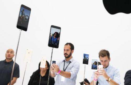 Attendees inspect the new iPhone 6 during an Apple special event at the Flint Center for the Performing Arts in Cupertino, Calif
