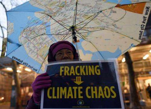 A woman holds an anti-fracking sign at a rally for a Global Climate Treaty December 10, 2014 near the United Nations in New York