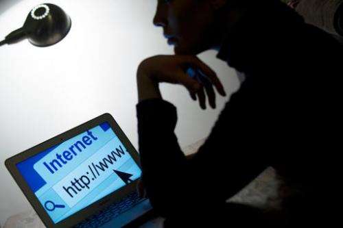A woman looks at a webpage while connecting to the Internet on March 15, 2013 in Paris