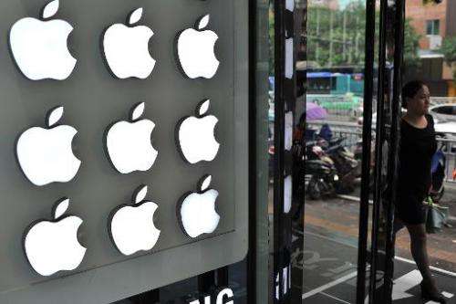 A woman walks past an Apple store in Hefei, east China's Anhui province, on September 10, 2014