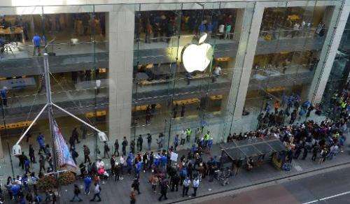 Customers queue outside an Apple store to buy the iPhone 6 in Sydney on September 19, 2014