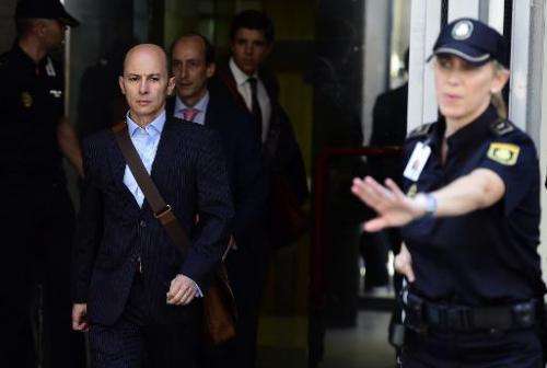 Disgraced ex-boss of Spanish wifi provider Let's Gowex Jenaro Garcia Martin (C) leaves the courthouse in Madrid on July 14, 2014