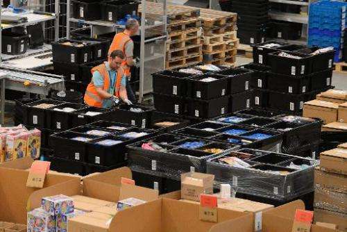 Employees work at the Fulfilment Centre for online retail giant Amazon in Peterborough, central England, on November 28, 2013