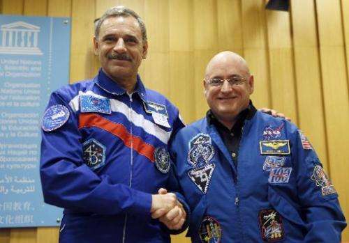 NASA astronaut Scott Kelly (R) and Roscosmos cosmonaut Mikhail Kornienko of Russia pose after a press conference on December 18,