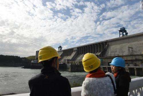 People visit the Danjiangkou dam in Danjiankou, China's central Hubei province, on November 2, 2014