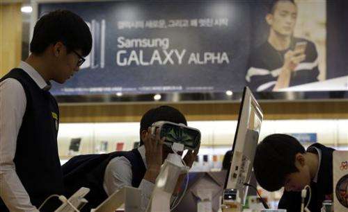 Samsung vows changes after mobile profit plunges