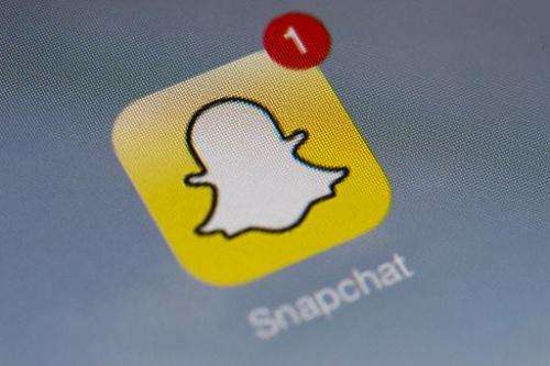 The logo of mobile app &quot;Snapchat&quot;, who recently announced ads will be woven into its service, is displayed on a tablet