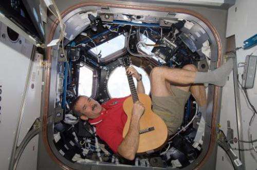This December 25, 2012, NASA photo shows Canadian Space Agency astronaut Chris Hadfield strumming his guitar in the Internationa