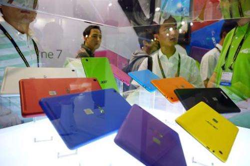 Visitors look at the Acer Iconia One 7 tablet at the Computex tech show in Taipei on June 3, 2014