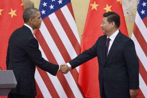 US President Barack Obama (L) and China President Xi Jinping shake hands following a bilateral meeting in Beijing on November 12