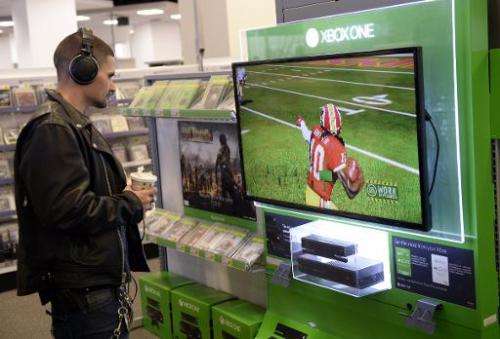 A customer looks at a display of Microsoft's Xbox One at Best Buy in Union Square in New York on November 19, 2013