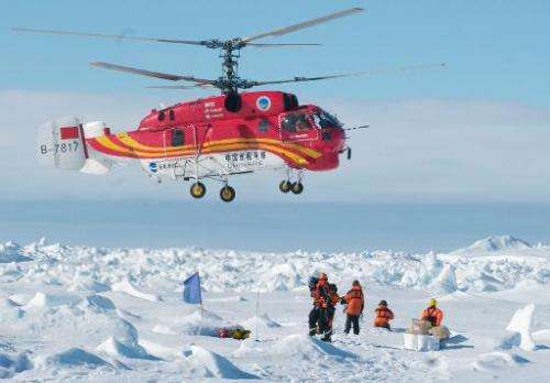 A helicopter from the Chinese ship Xue Long rescues passengers who spent Christmas on the icebound Russian research vessel Akade