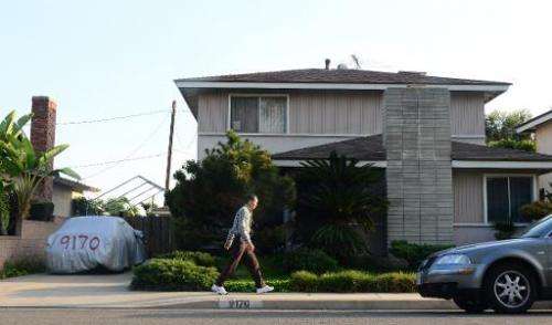 A man walks past the reported home of &quot;Satoshi Nakamoto&quot; in Temple City, east of Los Angeles, California on March 6, 2
