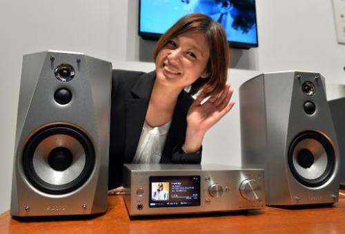 A model displays Japanese electronics giant Sony's hard-disc audio player system 'HAP-S1' and speaker system 'SS-HA1', in Tokyo,
