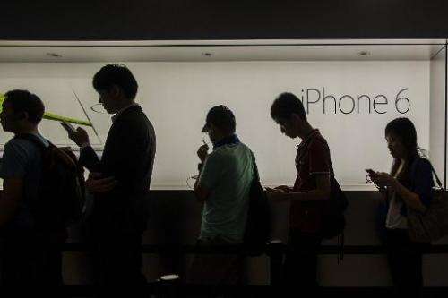 Customers queue outside an Apple store to buy the new iPhone 6 during its launch in Hong Kong, on September 19, 2014