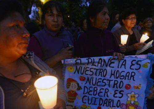 People attend a candlelight vigil organized by the Interfaith Council of Peru at a park in Lima, on November 30, 2014, before th