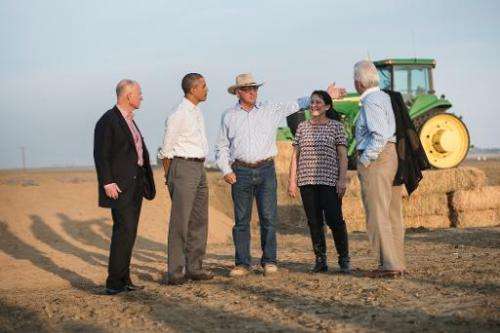 US President Barack Obama (2nd L) tours a farm in Los Banos, California, on February 14, 2014
