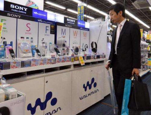 A customer checks out digital audio players of Japanese electronics giant Sony, at a shop in Tokyo, on May 13, 2014