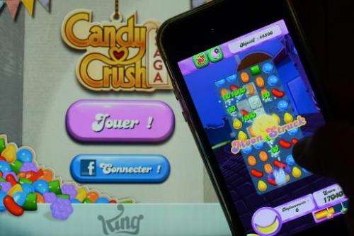 A man plays at Candy Crush Saga on his iPhone in Rome on January 25, 2014