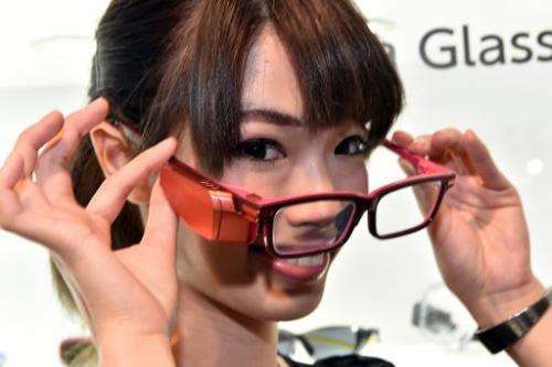A model displays prototype model of a smart glass 'Toshiba Glass', produced by Japanese electronics giant Toshiba, able to offer