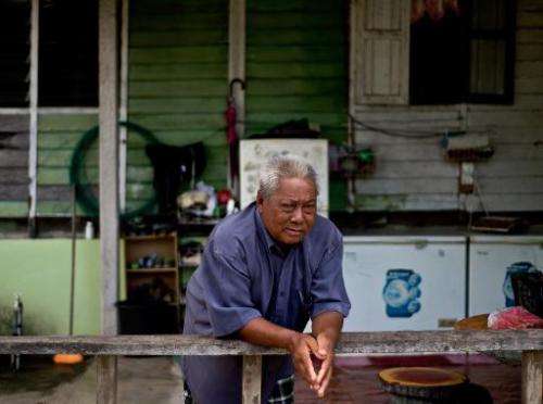 Fish listener Harun Muhammad at his home after returning from fishing in Setiu lagoons on June 8, 2014