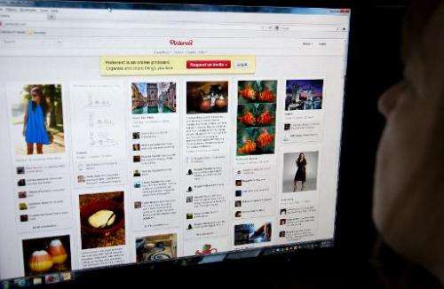 A woman looks at a Pinterest page on March 13, 2012