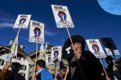 Protesters hold placards reading in German &quot;No to Ecopop-dead end&quot; during a demonstration in Bern against an immigrati