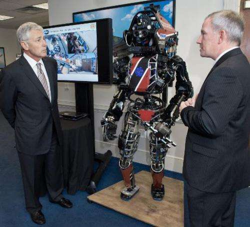 US Secretary of Defense Chuck Hagel (L) is shown the Atlas robot by Brad Tousley, head of DARPA's Tactical Technology Office, at