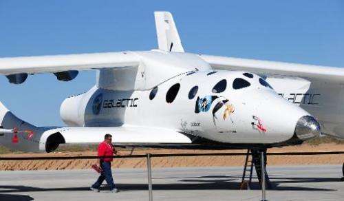 A man walks past the SpaceShipTwo vessel at Spaceport America, northeast of Truth Or Consequences, New Mexico, on October 17, 20