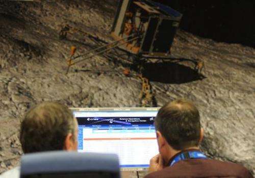 Scientists monitor the trajectory and data transmitted by the robot Philae aboard the European Space Agency's (ESA) comet-chasin