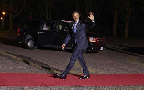 US President Barack Obama waves as he arrives at the Royal Palace Huis ten Bosch in The Hague on March 24, 2014
