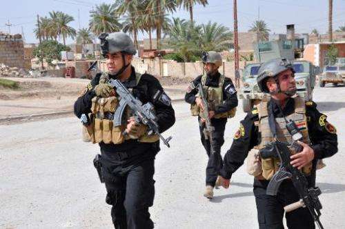 Members of the Iraqi Emergency Response Brigade patrol streets on June 24, 2014 in the western city of Ramadi in the Anbar provi