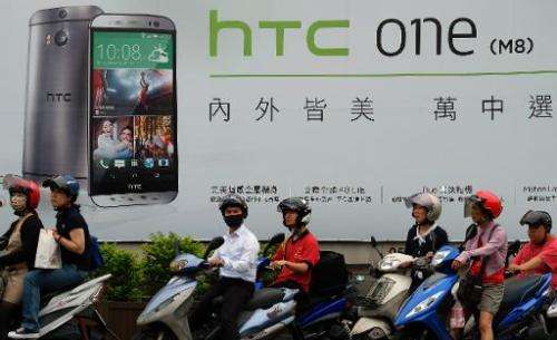 A billboard shows the latest HTC M8 smartphone in Taipei on June 6, 2014
