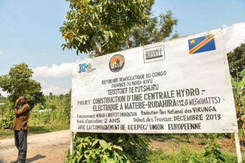A board advertising a hydroelectric project in the Virunga National Park is seen on June 17, 2014 in Matebe, some 75 kms north o