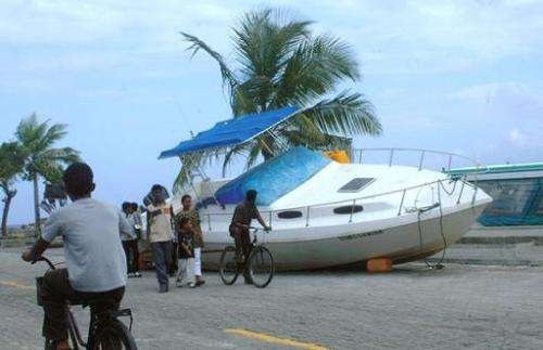 A boat lies in a street of Male after it was blown out of the water by a tsunami on December 26, 2004