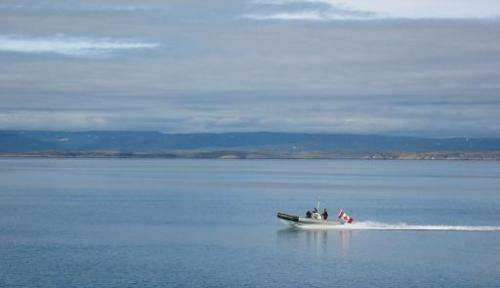 A Canadian Navy Zodiac races across the Arctic Ocean on patrol at the southern tip of Baffin Island, Canada, on August 09, 2007