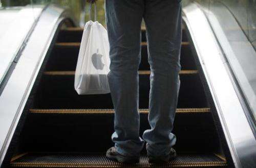 A Chinese man holds his new iPhone 6 in a bag in Shanghai on October 17, 2014