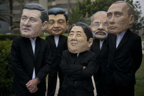 Activist depicting the PM's of Canada, Stephen Harper (L), India, Narendra Modi (2-R) and Japan, Shinzo Abe (C) and presidents o