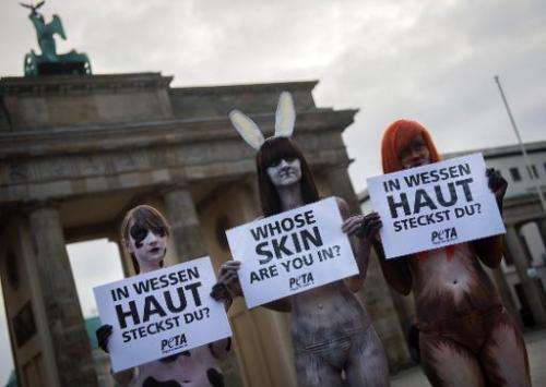 Activists from People for the Ethical Treatment of Animals (PETA), wearing body paint that looks like animal fur, protest at the