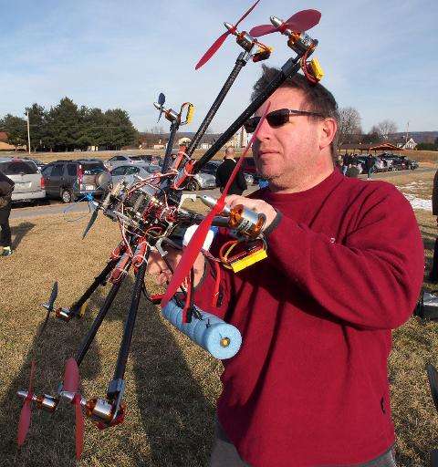 A drone flying enthusiast works on his drone during a DC Area Drone User Group meet-up on February 1, 2014