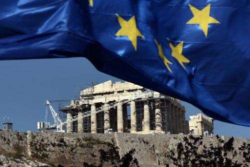 A European Union flag floats in the wind in front of the Acropolis in Athens on May 14, 2014