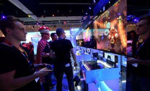 A gaming fan plays &quot;Jamestown&quot; on a PlayStation 4 console at the E3 video game show in Los Angeles on June 10, 2014
